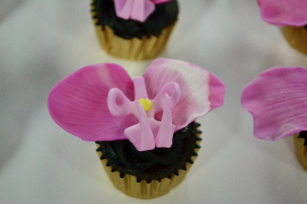 chocolate and lemon cupcakes with edible orchids by Sugar Street Boutique in Toronto.