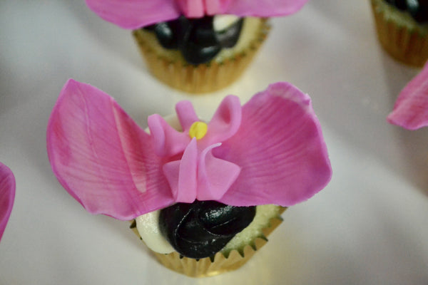chocolate and lemon cupcakes with edible orchids by Sugar Street Boutique in Toronto.