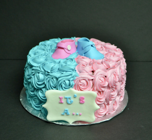 Vanilla Gender reveal baby cake with pink and blue rosettes and pink or blue smarties in the centre to reveal the gender of the baby by Sugar Street Boutique Toronto.