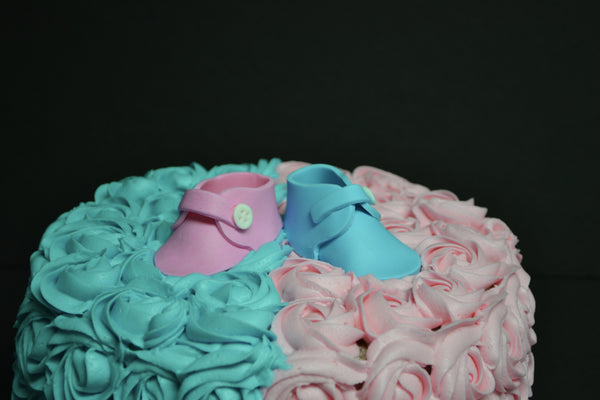 Vanilla Gender reveal baby cake with pink and blue rosettes and pink or blue smarties in the centre to reveal the gender of the baby by Sugar Street Boutique Toronto.