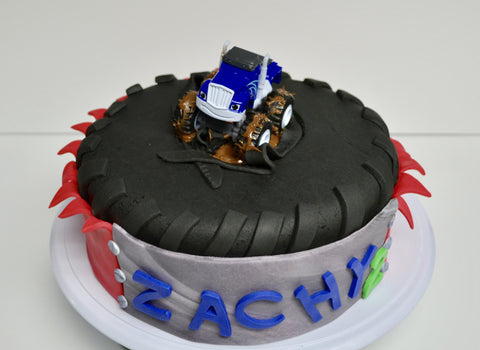 monster truck red velvet cake with a big tire by sugar street boutique toronto