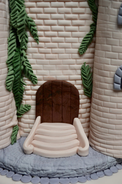 castle cake made of vanilla and fondant decorated with fondant rocks, fondant bricks, fondant castle perfect for a queen castle or king castle by sugar street boutique toronto