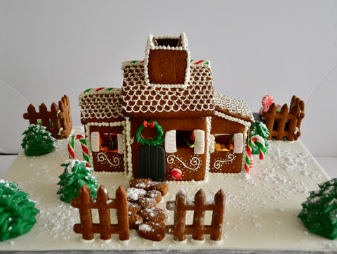 Gingerbread house with battery operated Christmas lights inside.  Decorate your home with this beautiful gingerbread house for Christmas and it is edible by Sugar Street Boutique Toronto. Gingerbread house toronto.